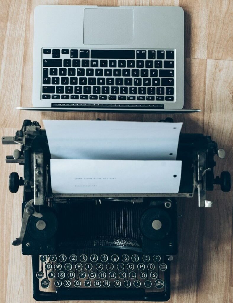 gray typewriter and MacBook